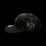 864 Richardson Bottomland Camo Performance PVC Patch Blackout Trucker Hat